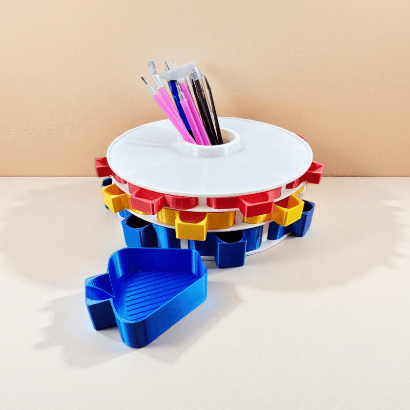 Rotating diamond art tray tower with a central slot holding multiple diamond painting pens and tools.